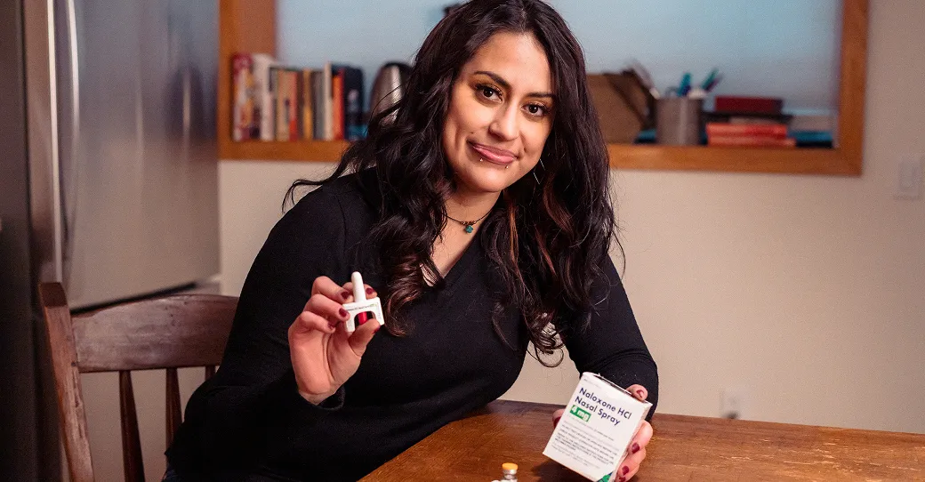 Woman shows naloxone to the camera.