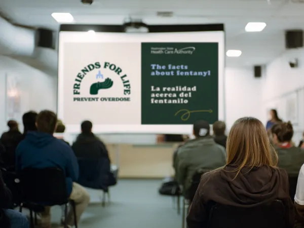 Image of a group viewing a presentation on a large screen