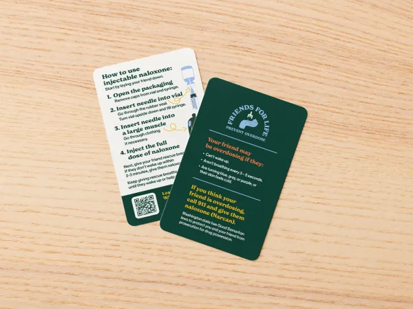 Image of a wallet card with one side on a dark background sharing information about how to use injectable Naloxone