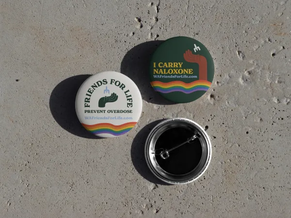 Image of 3 metal buttons with the Friends for Life logo and a rainbow Pride wave