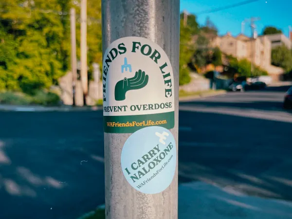 Image of a utility pole with Friends for Life Stickers on it