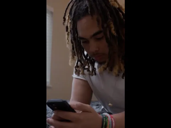 A person looking down at their phone.